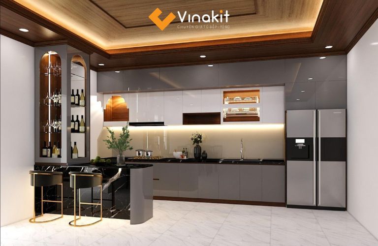 Quầy bar mặt đá đen sang trọng, tích hợp tủ rượu dáng cao và đèn hắt ấm áp